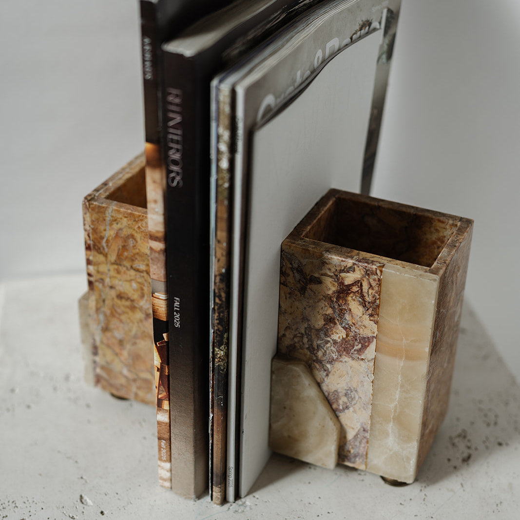 Decorative stone bookends with brass feet holding books