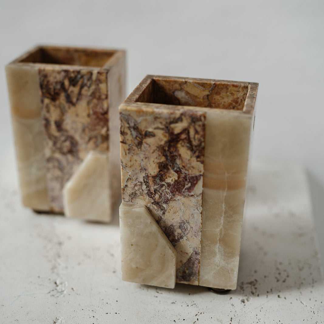 Decorative stone bookends with brass feet 