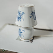 Small decorative porcelain lamp with blue floral design