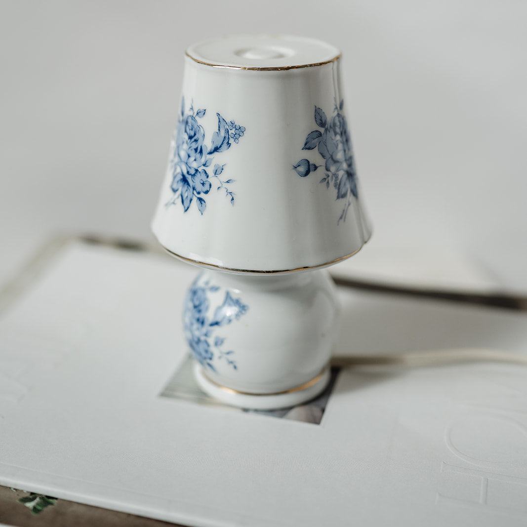 Small decorative porcelain lamp with blue floral design