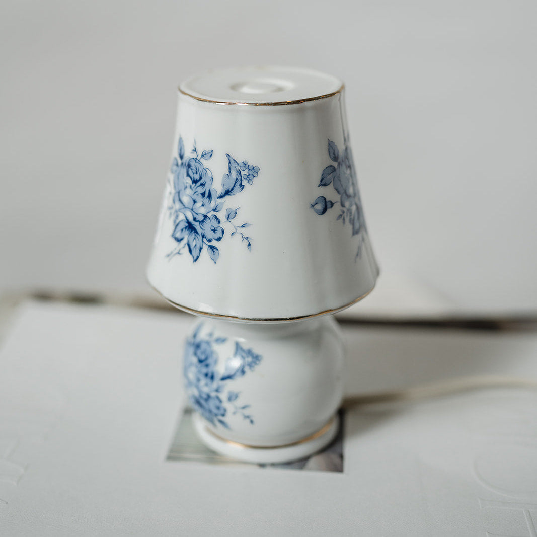Small decorative porcelain lamp with blue floral design