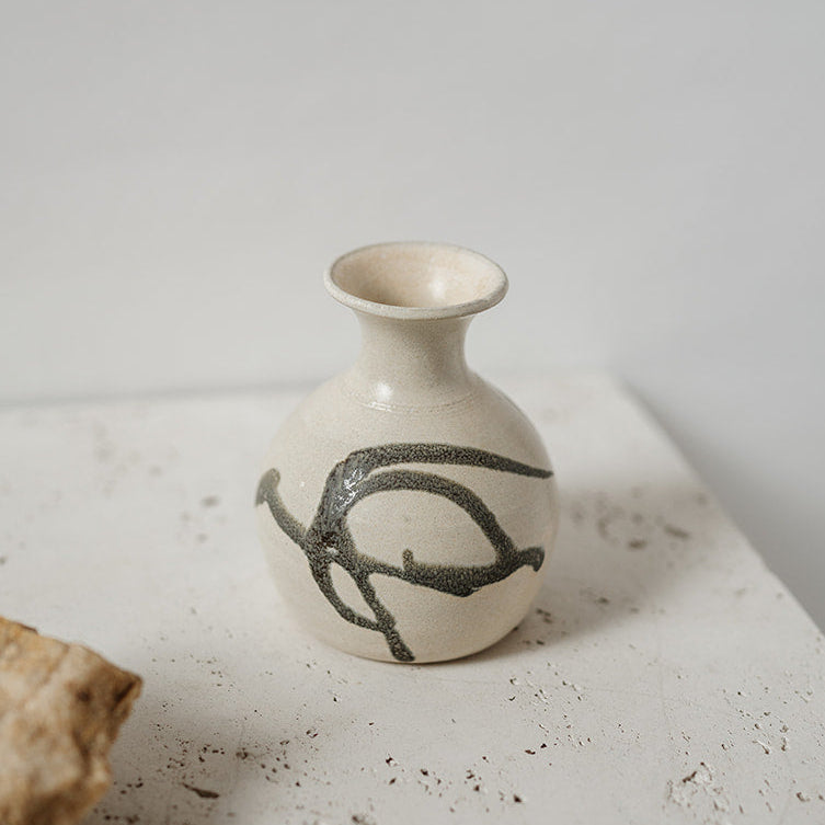 Small ceramic bud vase with black design 