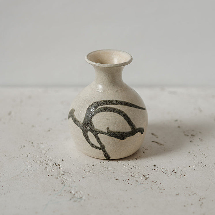 Small ceramic bud vase with black design 
