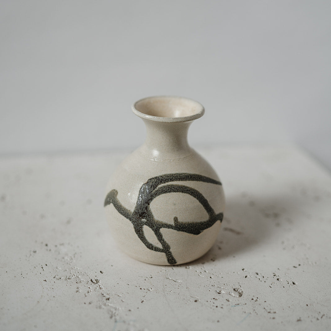Small ceramic bud vase with black design 