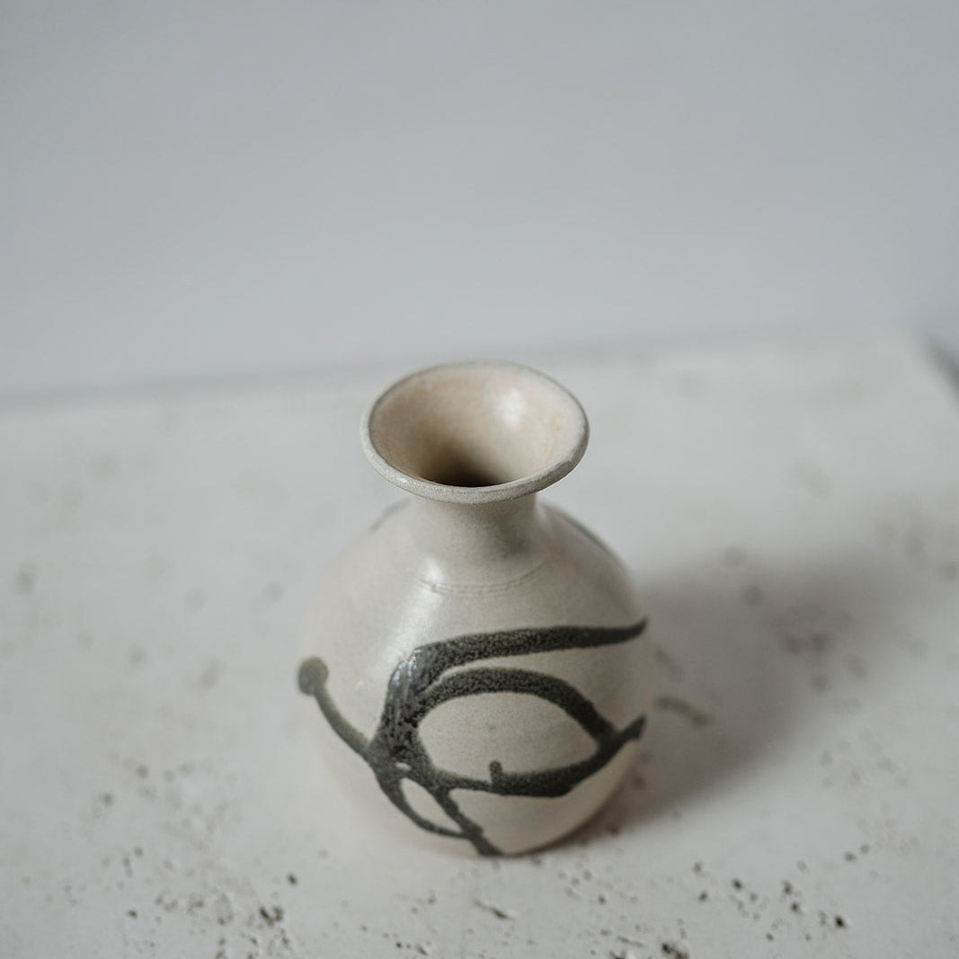 Small ceramic bud vase with black design 